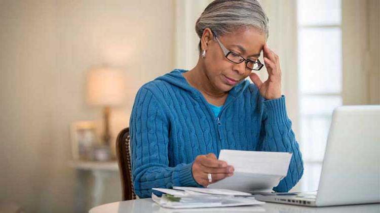 Mature woman studying a document related to Medigap plans.